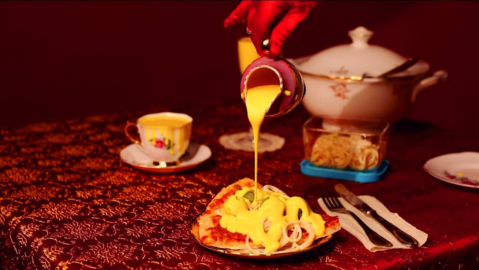 Velveeta melted cheese being poured over leftovers